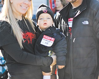 Anastasia and Emmanuel Pilatos of Campbell hold their 15-month-old son George, who is suffering from diabetes, as part of team T1 Destroyers.