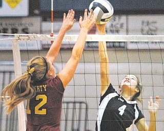 Canfield’s Jaqueline Cook (4) tries to get a spike past Liberty’s Leah Leshnack (12) during a Division II district semifinal volleyball match Tuesday night at Boardman High School. Canfield won in three games and will meet Salem in a district final on Thursday.