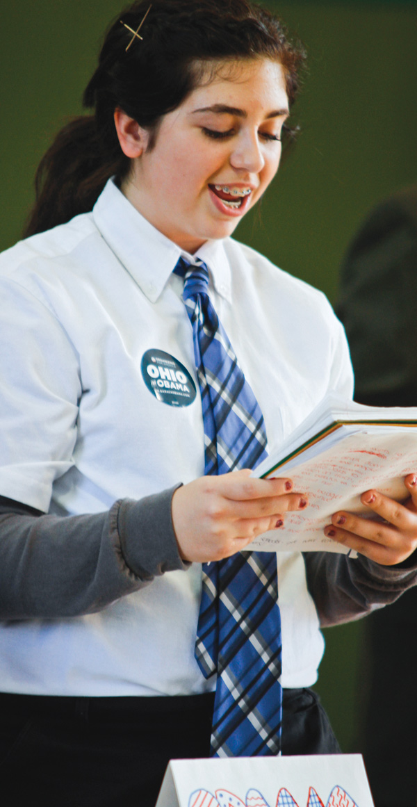 The 8th grade class at Holy Family put on a mock presidential debate on October 14, 2012. Emilee Mulhall plays President Obama.