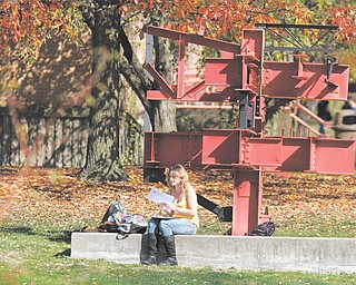 Amanda Huff man of Liberty, a sophomore at Youngstown State University, enjoys the unseasonably warm weather on campus. The area had a record-high temperature of 81 degrees Thursday, but the temperature will drop into the mid-40s by tonight and is expected to stay there through next Thursday.