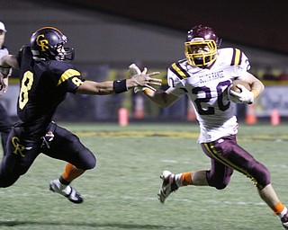 ROBERT K. YOSAY | THE VINDICATOR --..South Range #20 Jake Arsuffi eludes #8 Crestveiw matt Hardenbrook - as he makes a first down = second quarter.South Range at Crestview ..(AP Photo/The Vindicator, Robert K. Yosay)