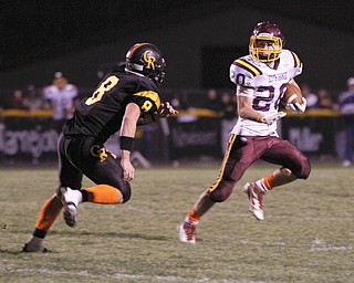 ROBERT K. YOSAY | THE VINDICATOR --..South Range #20 Jake Arsuffi eludes #8 Crestveiw matt Hardenbrook - as he makes a first down == second quarter..South Range at Crestview ..(AP Photo/The Vindicator, Robert K. Yosay)