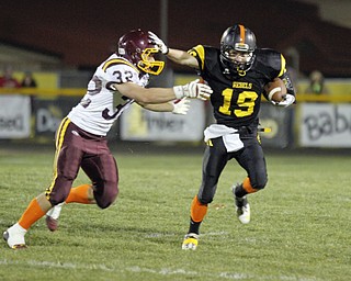ROBERT K. YOSAY | THE VINDICATOR --..Making his own block #19 Nick Blower stiff arms #32 Robert Seman as he runs for 12 yards and a first down- first quarter.South Range at Crestview ..(AP Photo/The Vindicator, Robert K. Yosay)