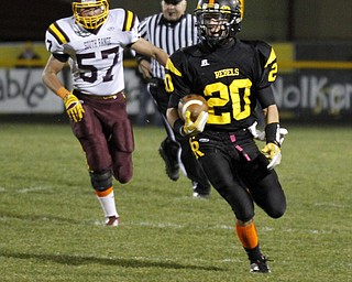 ROBERT K. YOSAY | THE VINDICATOR --..Crestview #20 Kris Simpson runs for a big gain leaving South Range #57 Ryan Haynes....South Range at Crestview - - First Quarter...(AP Photo/The Vindicator, Robert K. Yosay)