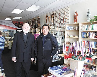 The Rev. Jeffrey Mickler, left, superior of the Society of St. Paul in Ellsworth, and the Rev. Tony Bautista, director of St. Paul’s Books and Gifts, are shown in the store that opened in August. Below, the store in Boardman is in a convenient location for
customers looking for religious and inspirational books and gift items. Photo by: Robert K. Yosay | The Vindicator
