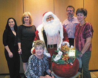 Promoting the holiday open house planned Friday, Saturday and Nov. 4 at D.D. and Velma Davis Education & Visitor Center at Fellows Riverside Gardens in Mill Creek MetroParks are Eileen Stankovich, foreground, and from left, April Stanislaw, Jeanne Simeone, the life-size Santa Claus to be raffled, Keith Kaiser and Janet Yaniglos.