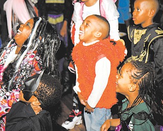 Children, dressed up for Halloween, laugh at the Black Knights Police Association’s party at Youngstown’s Wick Park Pavilion on Wednesday. About 100 kids attended.