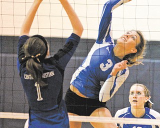 Jackson Milton’s Rachael Obradovich (3) spikes the ball against Kidron Central Christian defender Natalie Swift (1) during the fourth game of Wednesday’s Division IV regional volleyball semifinal at Solon High School. The Bluejays fell to the Comets, 3-1.