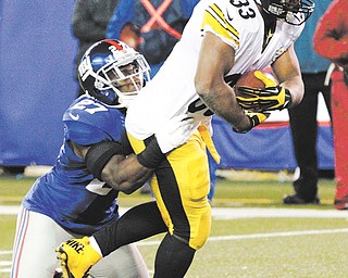 Steelers running back Isaac Redman (33) is tackled by Giants strong safety Stevie Brown (27) during Sunday’s NFL game in East Rutherford, N.J. Redman rushed for 147 yards and scored the touchdown that gave Pittsburgh the 24-20 win over New York.