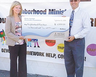 Neighborhood Ministries recently received a check for $2,000 from Home Savings Charitable Foundation. Mindy Wiesensee, left, AVP branch manager of McCartney Road Home Savings, is shown presenting the oversized check to Mark Samuel, executive director of Neighborhood Ministries. The funds will be used to support programs and services to low-income families and their children. For information about Neighborhood Ministries, call 330-755-8696 or email mark_samuel@ohionm.org.
