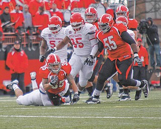 Youngstown State’s senior guard Lamar Mady (55) watches as teammate Jamaine Cook finishes off a run during Saturday’s win over South Dakota. Mady believes the Penguins have a good chance of making the playoff s if they finish 7-4.