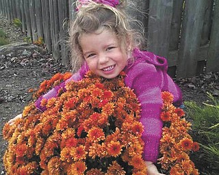 Three-year-old Harlow looks like she's giving a great big hug to these mums. She's the daughter of Jerret and Erin Kolesar of Boardman.