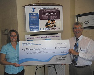 Alliance Family YMCA, a local, nonprofit organization, recently received a check for $5,000 from the Home Savings Charitable Foundation. Holly Gaston, left, from Home Savings Salem office, is shown presenting the check to Dale Nissley, executive director of the YMCA. Nissley said funds will go toward the renovation of space for an adult cycling center that will accommodate up to 30 participants. For information on the Alliance Family YMCA call 330-823-1930 or visit www.ymcastark.org.