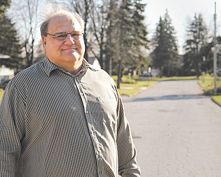 Campbell 4th Ward councilman Robert Yankle stands on Homestead Place in his ward. The street has not
been paved since the 1980s and likely will earn a spot on a list of roads that will get attention with money
from a levy voters passed Tuesday.