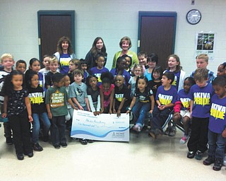 Home Savings Charitable Foundation recently donated a check for $5,000 to Akiva Academy in Youngstown to help the school to continue offering learning programs to an ever-widening range of students. Last year 100 percent of Akiva’s third- graders scored proficient or higher on the reading and math Ohio Achievement Tests. Students at Akiva enjoyed an educational visit from Home Savings. Adults, standing from left, are Tirtza Kohan, first-grade teacher and Judaic studies coordinator at Akiva; Rachel Smith, customer service representative of Home Savings Liberty office; and Kim Gennaro, branch manager of Home Savings Liberty office.