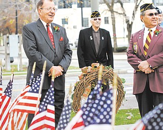 Col. Walter Duzzny, left, and Bill Pacak prepare to lay the wreath at the Civil War monument in downtown Youngstown during a Veterans Day observance Sunday.