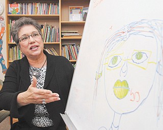 Carole J. Bopp, executive director of Hope House Visitation Center in Youngstown, shows a drawing made by a child who participates in supervised visitations at the center that serves Mahoning County.