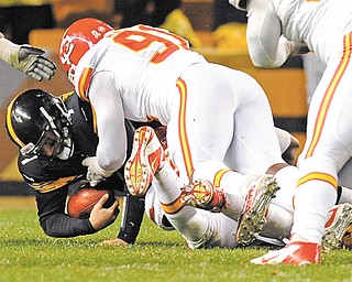 The Kansas City Chiefs’ Tamba Hali (91) assists as teammate Justin Houston (bottom of pile) sacks Pittsburgh
Steelers quarterback Ben Roethlisberger during the third quarter of Monday’s NFL game at Heinz Field in Pittsburgh. Roethlisberger left the game with a right shoulder injury, but the Steelers went on in 16-13 in overtime.