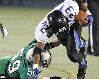 ROBERT K. YOSAY | THE VINDICATOR --..YCS #23 Ryan Grier is tripped up by #59 Jeremy Hugg as he tries to run around end during first quarter action.YCS vs Mogadore at Ravenna...(AP Photo/The Vindicator, Robert K. Yosay)