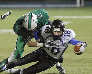 ROBERT K. YOSAY | THE VINDICATOR --..During first quarter action YCS #18 Ryan Coyier reaches for more yards as he is brought down by Mogadore #2 Hunter Van Camp.YCS vs Mogadore at Ravenna...(AP Photo/The Vindicator, Robert K. Yosay)