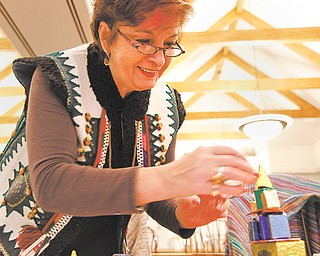 Bernadette Zubel of the Polish National Alliance makes a szopka at the Krakowiaki Polish Folk Circle craft show at the Austintown Public Library on Sunday. A szopka is a Polish Nativity scene that is handmade and decorated.