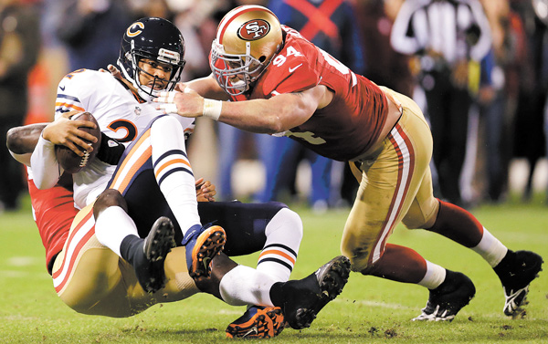 Chicago Bears quarterback Jason Campbell (2) is sacked by San Francisco 49ers linebacker Aldon Smith, left, as defensive tackle Justin Smith (94) converges during the first quarter of an NFL game in San Francisco on Monday. The 49ers won 32-7.