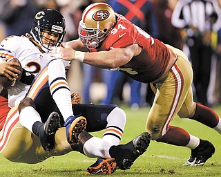Chicago Bears quarterback Jason Campbell (2) is sacked by San Francisco 49ers linebacker Aldon Smith, left, as defensive tackle Justin Smith (94) converges during the first quarter of an NFL game in San Francisco on Monday. The 49ers won 32-7.