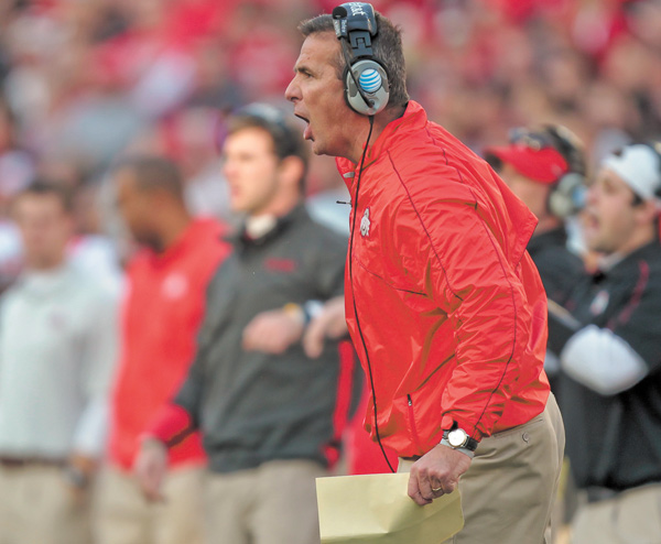 Ohio State coach Urban Meyer directs his team from the sidelines during the first half of a game against Wisconsin on Saturday in Madison, Wis. Ohio State won 21-14 in overtime.