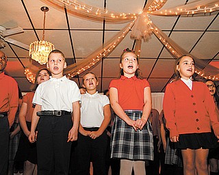 Third- through fifth-graders at St. Nicholas School of Christ Our Savior Parish in Struthers sing a variety of songs relating to giving thanks at the Mayors’ Prayer Breakfast on Tuesday. The event was sponsored by Mahoning Valley Association of Churches at the Mahoning Country Club in Girard.