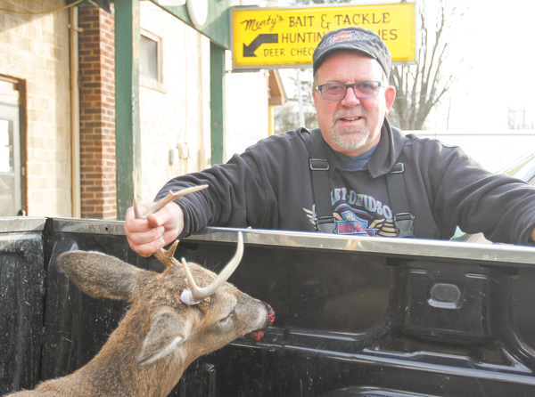 James Govenor of Cortland shows his buck that he bagged Monday morning on the opening day of the deer-gun season in Ohio.