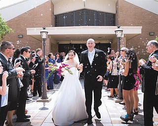 The May 26 wedding of Marlana LaCivita of Liberty and Guy Harris of Tampa was a joyous occasion. They are leaving St. Mary Church in Tampa into a crowd of well-wishers and bubbles. Photo submitted by Marie and Bob LaCivita of Liberty.