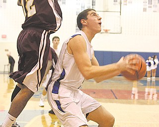 Poland’s Jacob Wolfe (5) looks to go up for a shot as Liberty’s John Helms Jr. (12) goes for a block Tuesday night. The host Bulldogs beat the Leopards, 51-41.