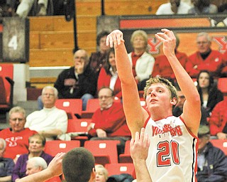 Youngstown State’s Bobby Hain (20) hits a jump shot over Geneva’s Matt Noyler (50) during the second half of Thursday’s game at the Beeghly Center. The Penguins silenced the Tornados, 93-50, with Hain posting 16 points and 11 rebounds.