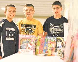 Jack Bucan, Ian Socha and Adam Price, all of McDonald, display toys they received for their birthday that they are donating to Akron Children’s Hospital Mahoning Valley. They turn 12 Wednesday (12-12-12) and will celebrate with a party at Towjo’s Bar and Grill in McDonald.