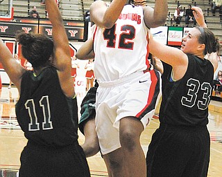 Youngstown State’s Brandi Brown (42) shoots while Wilmington’s Courtney Tucker (11) and Emily Zimmerman (33) try to defend during Sunday’s game at Beeghly Center. The Penguins rolled, 83-52.