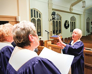 Margie Burnett, music director at Pleasant Grove Presbyterian Church in Youngstown, directs the adult choir in a rehearsal for Christmas vesper service planned at 4:30 p.m. Sunday. The service, in its 65th year at the church, is a Mahoning Valley tradition and signals the start of Christmas for many.