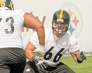 Pittsburgh Steelers offensive guard David DeCastro (66) practices during training camp at the team training facility in Latrobe, Pa. The Steelers drafted DeCastro with their first pick in the NFL draft in April, but the rookie injured his knee in a preseason game and has yet to play in the regular season. Steelers coach Mike Tomlin said
Tuesday that DeCastro will be worked in at right guard during practice this week and could start Sunday when the Steelers play the Dallas Cowboys.