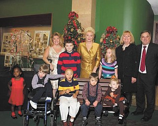 GFWC Ohio Warren Junior Women’s League celebrated its 43rd annual Champagne Luncheon, “An Officer and a Gentleman Christmas,” Nov. 16 at Packard Music Hall in Warren. Proceeds went to the Children’s Rehabilitation Center so no child will be turned away because of inability to pay for physical, developmental or speech therapy. Some of those who enjoyed the festivities were, front, Faith Rodgers, left, Johnathon Brown, Damon Reed, Justin Keener and Giuilianna Villio. Standing are Karen Margala, WJWL president; John Blake; Julie Vugrinovich, luncheon chairwoman; Katlyn Welch; Esther Garland, fashion coordinator; and Bob Foster, executive director of CRC. Children who attend the center modeled winter outfits during the fashion show and were given the clothes.