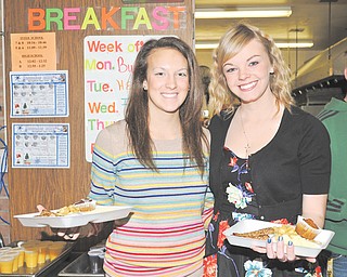 Springfield High School seniors Alexa Packard, left, and Erinn Coe serve breakfast Thursday to senior citizens during an annual National Honor Society service project.