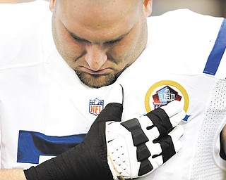 Indianapolis Colts guard Mike McGlynn, a graduate of Austintown Fitch High School, bows his head during a moment of silence for the victims of the Sandy Hook Elementary School shootings before a game against the Houston Texans on Sunday in Houston.