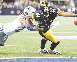 Pittsburgh Steelers wide receiver Antonio Brown (84) scores a touchdown as Dallas Cowboys cornerback Mike Jenkins (21) defends during the second half of an NFL football game on Sunday. The Cowboys outlasted the Steelers, 27-24, in overtime.