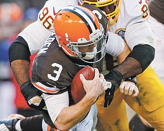 Redskins nose tackle Barry Cofield sacks Browns quarterback Brandon Weeden late in Sunday’s game in Cleveland. The 38-21 loss to Washington ended Cleveland’s slim playoff hopes, raised more questions about the rookie quarterback and likely triggered a massive overhaul in the weeks ahead.