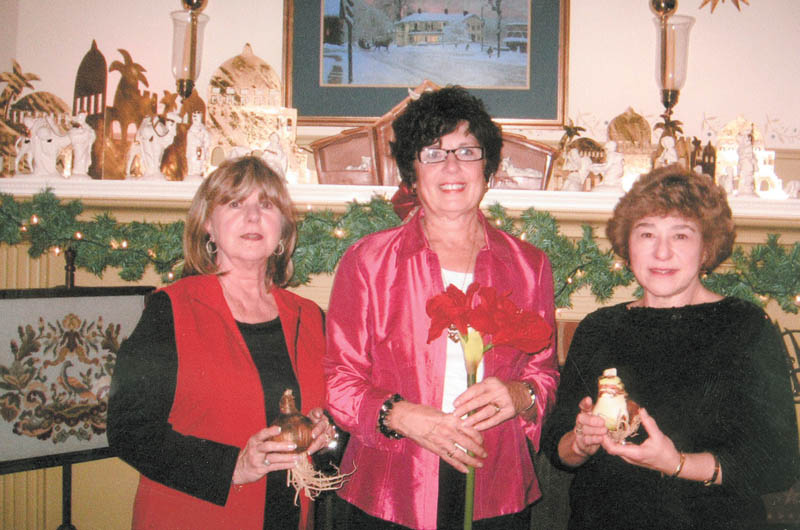 The Mignonette Garden Club Christmas luncheon was Dec. 4 at the home of Beverly Muresan. One of their projects is taking amaryllis bulbs to area nursing homes for residents and staff can watch the bulbs grow into large flowers. Holding the bulbs are Georgianna D’Andrea, left, president; Muresan, project director and distributor who is holding a full-grown amaryllis; and Valorie Zurawick, program chairwoman.
