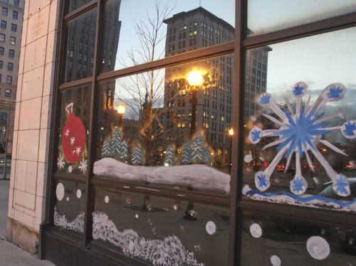 William d LEwis The Vindicator   Holiday decorations on windows of downtown buildings.
