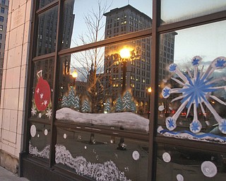 William d LEwis The Vindicator Holiday decorations on windows of downtown buildings.