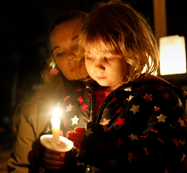 MADELYN P. HASTINGS | THE VINDICATOR..A candle light vigil took place in Lordstown to remember victims of the Newtown, Connecticut school shooting. (L-R) Cara Kowalczyk and Michelle Peterson, 4, of Lordstown reflect on the victims.... - -30-..