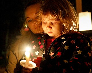 MADELYN P. HASTINGS | THE VINDICATOR..A candle light vigil took place in Lordstown to remember victims of the Newtown, Connecticut school shooting. (L-R) Cara Kowalczyk and Michelle Peterson, 4, of Lordstown reflect on the victims.... - -30-..