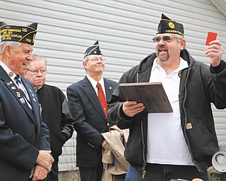 James Campbell, left, representative of the American Legion Department of Ohio, shares a laugh with Robert Raver, far right, commander of American Legion Post 472 in Youngstown, after Campbell presented the keys to Raver for the post’s new $300,000 facility at 472 E. Indianola Ave.