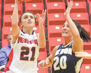 Youngstown State guard Liz Hornberger shoots past Akron’s Taylor Ruper during Thursday’s game at Beeghly
Center. Hornberger scored seven points and the Penguins won 80-71.