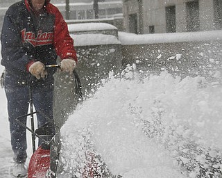 MADELYN P. HASTINGS | THE VINDICATOR..Employee of Mahoning County Facilities Management, Jeffrey Stanovcak, plows the sidewalks of downtown Youngstown on the first big snow storm of the year. .. - -30-..